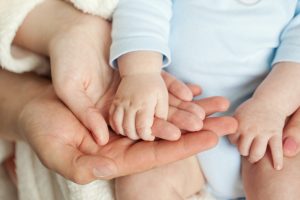 Mom,And,Dad,Hold,Baby’s,Hand